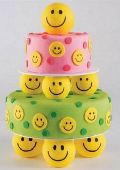 three tiered cake decorated with smiley faces