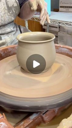 a person is making pottery on a potter's wheel