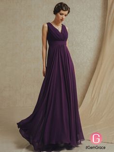 a woman in a long purple dress posing for the camera