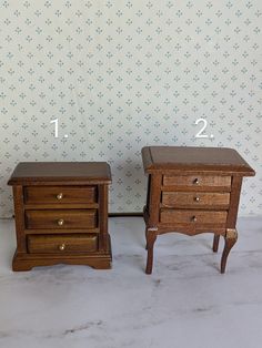 two small wooden nightstands sitting next to each other on top of a white floor