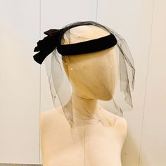 Vintage veiled hat with off white felt cap and large black bow in the back. Veil has tiny pearls  on it! Bow is folded like a fan. Black velvet trim. Fan bow is satin with velvet at knot. Super elegant. Made by Importina.  Has tiny hair comb attached with string to keep in place. MEASUREMENTS: Cap measures 19" around band. Is 7" across and is 2.5" deep. Veil hangs 6" from brim of hat in front.   CONDITION: good with a little wear on top under veil, not noticeable. See closeups. Veil Black, Tiny Hair, Hat With Veil, White Fascinator, Black And White Hats, Veiled Hats, Vintage Veils, Fascinator Hat, Sleek Hairstyles