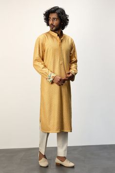 Yellow long kurta with thread embroidery all over and printed cuffs. Paired with a white dhoti pant. - Aza Fashions Long Sleeve Kurta With Embroidered Cuffs For Eid, Ceremonial Churidar With Embroidered Border And Long Sleeves, Ceremonial Long Sleeve Churidar With Embroidered Border, Festive Cotton Kurta With Embroidered Cuffs, Traditional Wedding Kurta With Embroidered Cuffs, Festive Long Sleeve Lawn Suit With Embroidered Border, Traditional Straight Kurta Set With Embroidered Cuffs, Traditional Set With Straight Kurta And Embroidered Cuffs, Eid Long Sleeve Kurta With Embroidered Cuffs