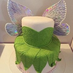 a cake decorated with green leaves and white frosting