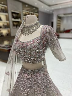 "Indulge in opulence with our Silver Bridal Lehenga BL-097. Adorned with intricate silver detailing, this luxurious lehenga embodies elegance and sophistication. Perfect for any bride seeking a stunning and exclusive wedding look. Take your bridal attire to the next level with this exquisite piece." Fabric: Net with Satin Silk Lining! WASH CARE INSTRUCTIONS - Please Dry clean only when it is applicable! Ready to Ship! Silver Lehenga Bridal, Silver Bridal Lehenga, Luxurious Lehenga, Silver Lehenga, Bridal Attire, Red Carpet Outfits, Wedding Look, Bridal Bangles, Bridal Stores