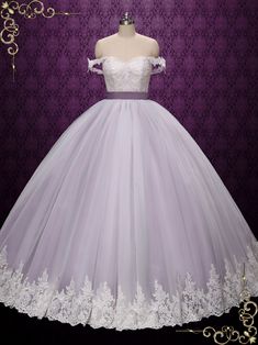 a white wedding dress on display in front of a purple background