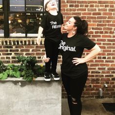 a woman standing next to a little boy in front of a brick building with the words the original on it