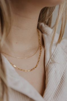 Trendy, light, and simple. Our mini paperclip necklace is the perfect size for layering or for a dainty addition to everyday wear. 18K gold filled Handmade right here in our store in Steamboat Springs, CO Length of chain = 16" with a 3” extender (up to 19" long) Nickel Free Hypoallergenic Care: Avoid salt water, chlorine and harsh chemicals. Polish regularly with a jewelry cloth to improve shine. Be mindful that perfume, lotion and hair products may cause tarnishing. We recommend taking jewelry Batik Pillow, Cake Stand Ceramic, Perfume Lotion, Paperclip Necklace, Sunflower Pendant, Necklace Ideas, Steamboat Springs, Gold Collection, Olive Wood