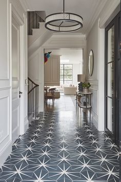 the hallway is decorated in white and blue with star patterned tiles on the flooring