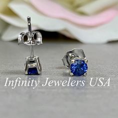 "The stud earrings pictured are lab created blue sapphire #5926 -Approximate total carat weight: .50ctw -Center Stone Size: 4mm - approx. .25ct each diamond equivalent -Gem Type: lab created sapphire -Stone Shape: round -Stone Clarity: VS2 -Stone Color: Blue - Shown in friction backs -Metal Type and Purity: 14k white gold -Setting: 4 prong basket style -Backing: Friction back (earring backs are subject to change due to availability) -Country of Manufacturing: USA (Michigan) For customization ple Blue Earrings With Prong Setting For Anniversary, Classic Blue Sapphire Earrings, Classic Blue Lab-created Sapphire Earrings, Blue Sapphire Earrings For Anniversary, Blue Brilliant Cut Earrings For Anniversary, Blue Lab-created Sapphire Round Cut Earrings, Blue Sterling Silver Earrings With Brilliant Cut, White Gold Sapphire Birthstone Earrings, Brilliant Cut Sapphire Earrings For Anniversary