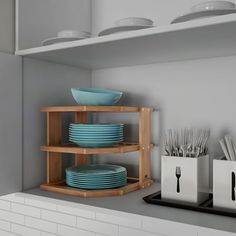 a shelf with plates and utensils on it