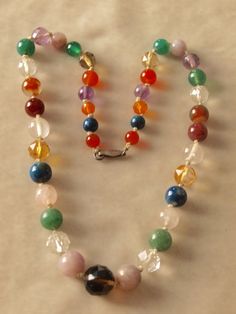 This necklace is British in origin. It has amethyst, rock crystal, carnelian, sodalite, chrysoprase, rose quartz, and several other stones. The necklace is 17 inches long and the beads range in size from 5mm to 15mm and they beads are faceted and some are plain. They are hand knotted in between each bead and the clasp is marked sil for silver.. Follow me on instagram@jettesjewels. Spiritual Multicolor Faceted Necklace, Vintage Multicolor Gemstone Beads And Cabochons, Multicolor Faceted Gemstones For Healing, Vintage Multicolor Natural Gemstones, Vintage Multicolor Beads And Cabochons For Healing, Crystal Carnelian, Amethyst Rock, Smoky Quartz Pendant, Fluorite Stone