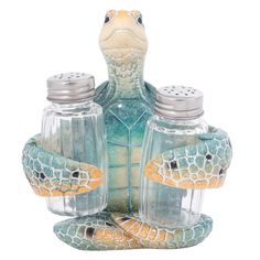 two salt and pepper shakers sitting on top of a turtle