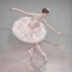 a ballerina in a pink tutu and tiara