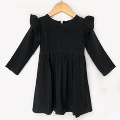 This gorgeous black linen dress can be worn all year long! It has flutter sleeves and long sleeves and closes with a zipper in back. Fits true to size. Cotton Ruffle Sleeve Dress For Brunch, Ruffle Sleeve Cotton Dress For Brunch, Non-stretch Cotton Long Sleeve Dress, Non-stretch Long Sleeve Cotton Dress, Chic Cotton Ruffle Sleeve Dress, Solid Dress With Pleated Sleeves For Fall, Elegant Cotton Dresses With Elastic Sleeves, Elegant Cotton Dress With Elastic Sleeves, Fall Dresses With Pleated Sleeves