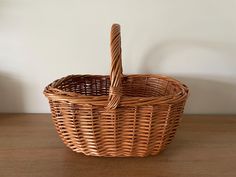 a wicker basket sitting on top of a wooden table