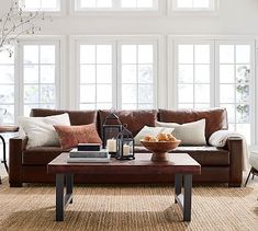 a living room filled with furniture and lots of windows