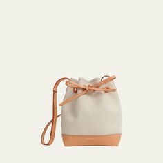 Mansur Gavriel bucket bag in canvas linen and cotton  Adjustable crossbody strap, 24.5"L Self-tie drawstring closure  Approx. 9.8"H x 7"W x 4.8"D Made in Italy Canvas Bucket Bag With Canvas Lining, Cream Canvas Bucket Bag, Beige Canvas Bucket Bag, Cream Canvas Bucket Bag With Adjustable Strap, Beige Canvas Pouch Bucket Bag, Canvas Crossbody Bucket Bag With Leather Trim, Modern Canvas Crossbody Bucket Bag, Beige Canvas Bucket Bag With Detachable Strap, Canvas Bucket Bag With Adjustable Strap