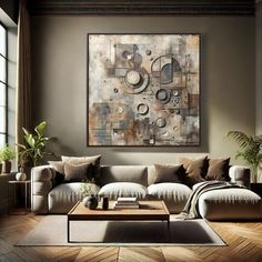 a living room filled with furniture and a large painting on the wall above it's coffee table