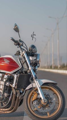 a red and silver motorcycle parked on the street