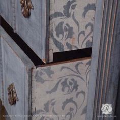 the drawers are painted blue and white with floral designs on them, as well as metal handles