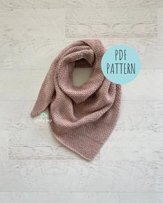 a pink knitted scarf on a white wooden background with the text, free pattern