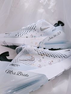 a pair of white sneakers with pearls on the soles are sitting in a plastic bag