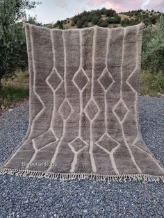 a large gray blanket sitting on top of gravel