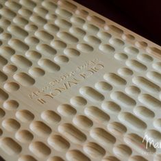 a close up view of the bottom part of a mat with holes in it and words on it