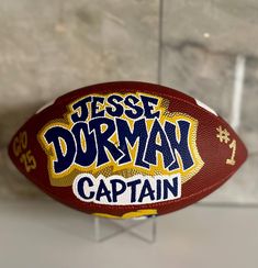 a close up of a football with the words jese dorman captain on it