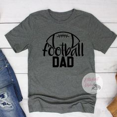 Proud Football Dad. The perfect dad shirt to wear for game day, practice, or out and about! Show your player who their biggest fan is. Express your style with our range of cool printed t-shirts and graphic tees. Football Dad Shirts, Dad Fashion, Sports Shirt, Deep Gray, Printed T Shirts, Out And About, Dad To Be Shirts, Sport T Shirt, Football Shirts