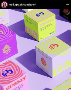 six boxes with different designs on them sitting next to each other in front of a purple background