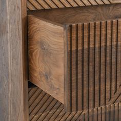 a close up of a wooden shelf with wood slats on it's sides