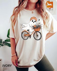 Comfort Colors® Cute Halloween Ghost Shirt, Halloween Women's Shirt, Fall Shirt, Halloween Party Shirt, Spooky Season Shirt, Autumn Shirt, 1057 -If you would like any other color of t-shirt, sweatshirt, hoodie, etc., please let me know by sending a message. I will provide it for you. ----------- How to Order Your Custom Design T-shirt ---------- * Choose your t-shirt color * Choose your size * PLEASE make sure all your order's steps Comfort Colors introduces the "Comfort Colors 1717" garment-dye Casual Short Sleeve Shirt For Halloween, Casual Crew Neck Shirt For Halloween, Casual White Shirt For Halloween, Casual Halloween Shirt With Cartoon Print, White Novelty Halloween Shirt, Novelty White Halloween Shirt, Novelty White Shirt For Halloween, Cute Halloween Ghost, Ghost Shirt