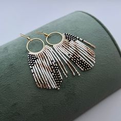 These beaded hoops earrings with  abstract fringe are made of high quality Japanese beads. They are lightweight and comfortable. These beaded earrings are an amazing gift for special occasions: holidays, birthdays, anniversaries, Christmas, Valentine's Days and more. It can also be jewelry for the bride or bridesmaids at a boho wedding. This pair is a mix of ethnicity and modern casual style. I create for women who love to feel completely different. -------------------------------------------- ✦ The Details: ✔ Made with quality Japanese beads ✔ Made using strong bead weaving thread.  ✔ Lenght: app. 3.1 inches ✔ 24k gold plated earrings hooks There may be some color discrepancies which is due to the different monitor settings ✦ All  earrings hooks are nickel and lead free! ✦ More great boho Bohemian Fringe Dangle Hoop Earrings, Bohemian Dangle Fringe Hoop Earrings, Handmade Artsy Dangle Hoop Earrings, Bohemian Handmade Tassel Earrings, Fringe Beaded Earrings, Japanese Beads, Dangle Earrings Boho, White Fringe, Casual Jewelry