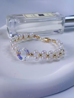 Super shiny Swarovski Crystal  with Mermaid beaded bracelet   14mm genuine  Swarovski Crystal 4139 cosmic ring /14K plated bead /6mm mermaid bead  Bracelet Size : 15cm Please let me know if your special size is required.  This dazzling Swarovski crystal bracelet is handcrafted with 100% genuine Swarovski 4139 cosmic ring， clear AB (Aurora Borealis), which have a super shimmery, iridescent effect and reflect a rainbow of colors.  Lovingly handmade in my home studio in Sydney. To help care for you Round Pearl Crystal Bracelet For Gift, Sparkling Crystal Round Bracelet, Round Beaded Bracelets With Spacer Beads For Party, Sparkling Round Crystal Bracelet, Crystal Bracelet With 8mm Round Beads, 8mm Crystal Bead Bracelet, Round 8mm Bead Jewelry For Party, Party Jewelry With 8mm Beads, Round 8mm Beads Jewelry For Party