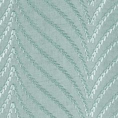 an upholstered fabric with silver threadwork on the edges and diagonals in rows