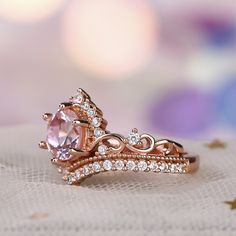 Duchess, princess or queen, this crown fashion ring is a sweet look for the one who has your heart. Created in sleek sterling silver, this tiara-shaped design features intricately looping scrollwork and a scattering of shimmering round stones. Additional stones are set on chevron shank to assure sparkle from every angle. Delicate and romantic, this ring is the princess-perfect choice for her.Carat Weight: 1.25 ctStone Size: 7 mmStone Type: Jeulia® StoneNumber of Stones: 1 Stone Shape: RoundStone Color: Fancy PinkCarat Weight: 0.734 ctStone Size: 1.7,1.3 mmStone Type: Jeulia® StoneNumber of Stones: 36 Stone Shape: RoundStone Color: Diamond WhiteWeight: 4.9 gWidth: 13.2 mmHeight: 5.9 mmThickness: 2.8 mmMaterial: Plating Color: Elegant Pink Crown-shaped Jewelry, Pink Crown-shaped Wedding Jewelry, Pink Princess Jewelry For Wedding, Princess Style Cubic Zirconia Wedding Jewelry, Elegant Rings With Crown Design, Elegant Round Crown Anniversary Ring, Luxury Crown-shaped Promise Ring, Luxury Crown Shaped Promise Ring, Crown Shaped Ring With Prong Setting For Promise