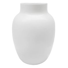 a white vase sitting on top of a table