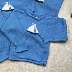 Original Baloo Baleerie design Sailboat sweaters make a great gift for the little ones in your life! Blue sweater with a Sailboat motif is 100% cotton. Hande-loomed in Maine. Machine washable.  Features: *Rolled hem pull over  *made from 100% American cotton *Hand Loomed in Maine *Colorfast and easy care *Machine wash & dry * Sweaters are pre-washed to minimize shrinking Custom orders in the following sizes 3-6 months 6-9 months 9-12 months 12-18 months 2T 4T *please contact us for additional sizes Blue Cotton Knit Sweater, Nautical Long Sleeve Sweater For Winter, Nautical Long Sleeve Sweater For Fall, Nautical Cotton Tops For Fall, Long Sleeve Cotton Sweater For Playwear, Cotton Long Sleeve Sweater For Playwear, Cozy Long Sleeve Sweater For Playtime, Cozy Cotton Knitted Sweatshirt, Playful Cotton Sweater For Playwear