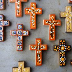 many different colored crosses are on the table together, and one is painted with dots