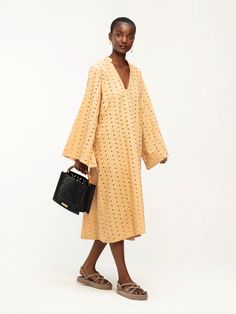 Introducing our Rama Dress in Binta Camel, a chic addition to your resort wardrobe. Crafted from 100% natural cotton with intricate eyelets, this calf-length caftan features bell sleeves and a v-shaped collarless neckline, offering effortless style and comfort for your daytime adventures. New Caftan 100% cotton Midi length Unlined V-neckline Bell sleeves SIZINGSizes XS to 3XLCAREMachine wash cold with similar colors. Hang dry. Resort Wardrobe, Cotton Caftan, Caftan Dress, Silk Crepe, V Shape, Natural Cotton, Midi Length, Effortless Style, Shift Dress