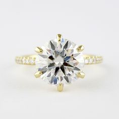 a yellow gold engagement ring with a round cut diamond