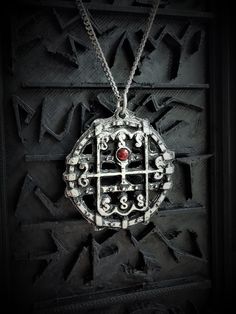 This Sigil of Amon necklace is an handmade pewter sculpture with a gem of your choice (my favorite is the red abalone, if you are looking for a very nice bloody red) This seal of Amon is one of the 72 Sigils of Goetia from Ars Goetia's Demonology This Sigil of Goetia pendant is sold with a free 18'' stainless steel chain, if you would like to have a different length for the chain, you can write the desired length in the private note section when ordering :) This Seal of Amon is a pendant of 3cm Collectible Gothic Metal Necklace, Red Spiritual Metal Jewelry, Symbolic Antique Finish Necklace As Collectible, Spiritual Red Metal Necklace, Symbolic Antique Finish Necklaces For Collectors, Red Sterling Silver Necklace With Oxidized Finish, Nickel Free Gothic Necklaces For Collectors, Nickel-free Gothic Necklaces For Collectors, Gothic Nickel-free Necklaces