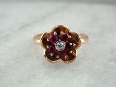 a close up of a ring with a flower shaped design on it's center