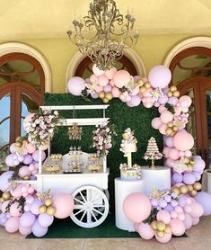 a dessert cart decorated with pink, purple and gold balloons