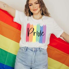 The "Pride Paint Strokes" Graphic Tee is more than just a garment; it's a vibrant celebration of diversity, love, and unity within the LGBTQ+ community. Crafted with meticulous attention to detail, this tee combines comfort with style, making it the perfect choice for expressing your pride and solidarity. The colorful rainbow paint strokes create a bold and eye-catching design, symbolizing the spectrum of identities and experiences within the LGBTQ+ community. Whether you're marching in a pride Cotton T-shirt With Rainbow Print For Pride, Relaxed Fit Crew Neck T-shirt For Pride, Trendy Crew Neck T-shirt For Pride, Trendy Multicolor Pride T-shirt, Trendy Rainbow Top For Pride, Pride Multicolor Short Sleeve Tops, Spring Multicolor Slogan T-shirt, Rainbow Short Sleeve Top For Pride, Multicolor Short Sleeve Tops For Pride