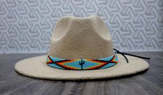 100 % Leather Hat-band is Hand Beaded with intricate beaded patterns by skilled Artisans Inspired by Native American crafting techniques and Indian beaded jewelry Beaded portion about 19.0 inches, handmade products, dimensions may slightly vary. Adjustable ties in the back. Hypoallergenic - Made with non-reactive Materials 100 percent Natural Environment friendly materials. Handcrafted with tiny Cubic Zirconia Seed Beads with beautiful and detailed beadwork. Western Style Adjustable Beaded Jewelry, Handmade Multicolor Southwestern Hats, Handmade Southwestern Multicolor Hats, Hand-stitched Adjustable Bohemian Jewelry, Artisan Hand-stitched Adjustable Jewelry, Handmade Southwestern Multicolor Hat Band, Southwestern Beaded Hat Bands For Summer, Bohemian Handmade Hat Bands For Gift, Adjustable Multicolor Western Jewelry