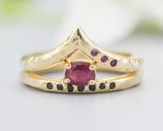 Set of 2 Oval faceted ruby ring and black spinel on 14k gold band set with 14k gold with hammer band ring with tiny 3 ruby on the side. Free resizing Oval faceted ruby ring Gemstone measures(ruby): 4.7 mm W x 3.5 mm H Gemstone measures(black spinel): 1.3 mm W 14k gold ring with 3 ruby on the side: * 14k gold and 2 mm band Gemstone measures: 1.4 mm W SKU: GA-2GY3-U2N6 Hand Forged Ruby Ring In Red, Hand Forged Red Ruby Ring, Hammered Band, Textured Ring, Red Band, Labradorite Ring, Black Spinel, 14k Gold Ring, Ring Gemstone