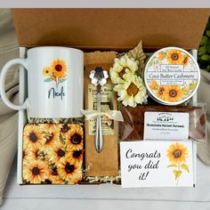 a sunflower themed gift box with coffee mugs, note cards and other items