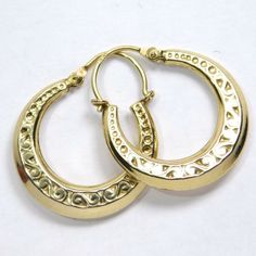 Super nice little old 14K gold hoop earrings with a fancy scrolling engraved and embossed pattern. They measure ¾ inch wide by ⅞ inch tall marked 14K. They weigh 1.5 grams. The condition is very good. Vintage Round Hoop Earrings With Intricate Design, Vintage 14k Gold Earrings With Intricate Design, Victorian Engraved Yellow Gold Earrings, Victorian Style Engraved Yellow Gold Earrings, Antique Gold Engraved Earrings, Ornate Gold Brass Hoop Earrings, Vintage 14k Gold Engraved Earrings, Brass Filigree Hoop Earrings, Traditional Engraved Yellow Gold Earrings